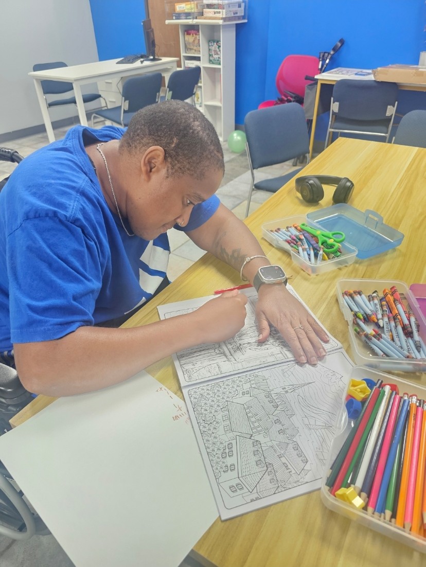 Marci participating in an activity at the Illuminate Care center